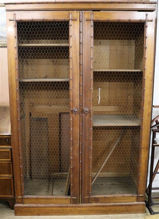 A pine faux bamboo and mesh two door cupboard W.132cm